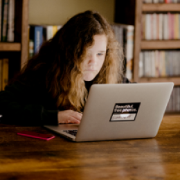Image of teen girl sitting at a computer