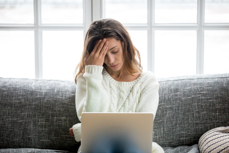 women holding her head due to stress