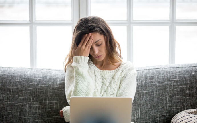 women holding her head due to stress