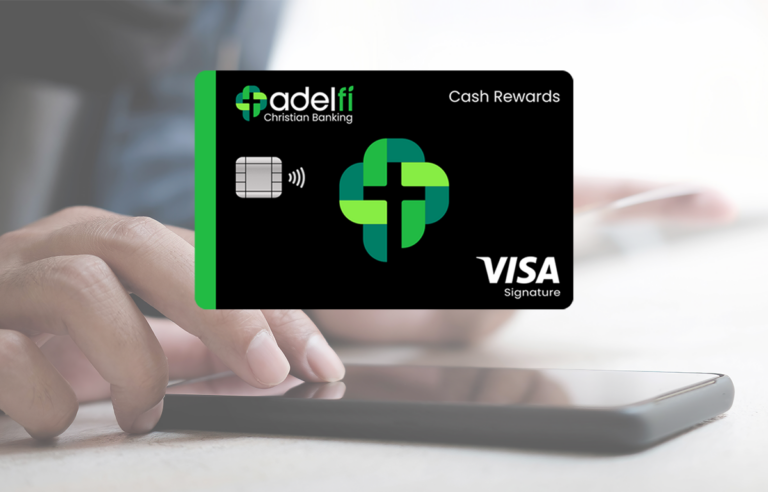 Person texting with credit card in hand