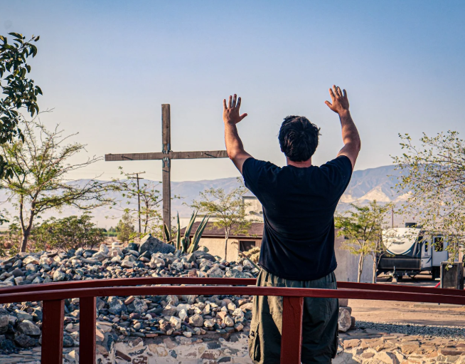 Man in front of cross at River's Edge Ranch