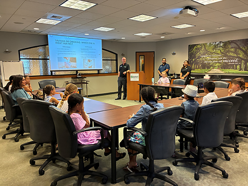 Children learning about financial literacy at AdelFi Corporate Headquarters
